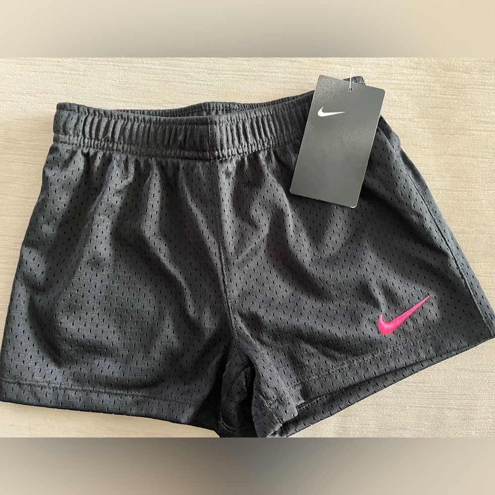 Kids black Nike shorts with bright pink swoosh . Kids size medium 5-6 yrs. NWT